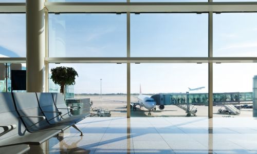 Airport terminal, people going to airplane in background